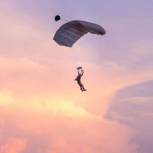 skydiver silhouetted against a pink and purple sky 2026 01 05 01 13 21 utc